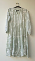 Beautiful pastel-colored handcrafted Chikankari kurta by LVW Fashions featuring intricate Lucknow embroidery and a midi length.