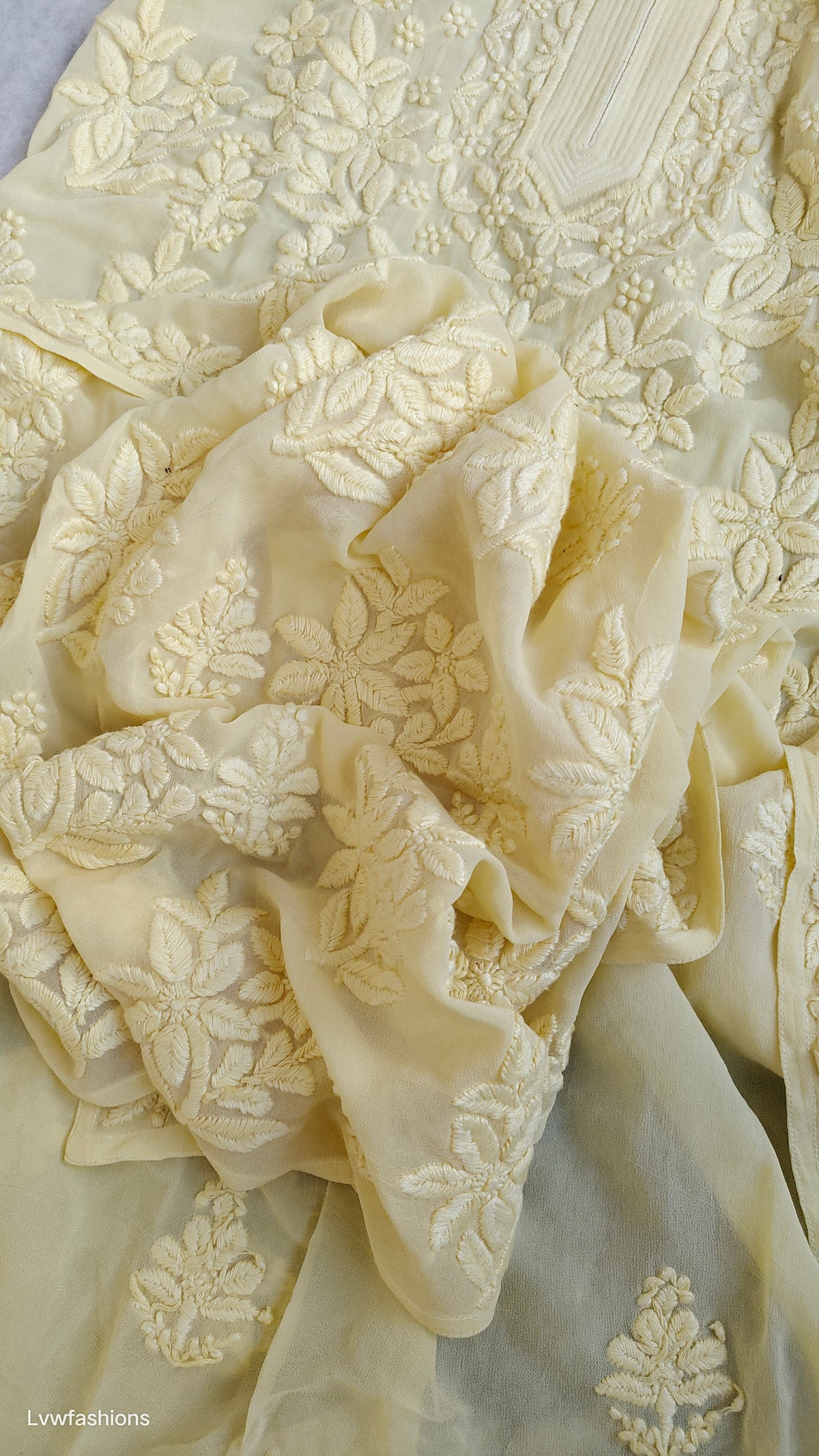 A pastel yellow georgette chikankari kurta with intricate white embroidery, handmade in Lucknow by LVW Fashions.