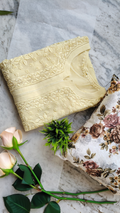 A pastel yellow georgette Chikankari kurta with intricate white embroidery, handmade in Lucknow, by LVW Fashions.
