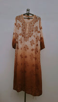 A beige Adaya premium georgette long kurta with intricate Lucknow chikankari embroidery, featuring neck and daman embroidered details.