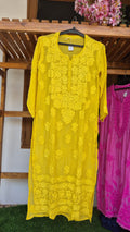 Turmeric yellow silk long kurta with intricate white chikankari embroidery by LVW Fashions, handmade in Lucknow.