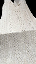 Beautiful white sleeveless A-line Anarkali dress with luxurious look and Chikankari embroidery, 50-inch length by LVW Fashion Luxurious.