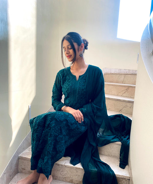 A model wearing the LVW Fashion Luxurious Chikankari Adaya Luxurious Look premium georgette 3-piece set, showcasing intricate detailing.