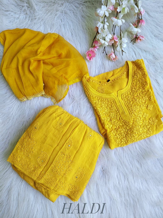 Beautiful turmeric yellow Gharara set with intricate Chikankari embroidery from LVW Fashion, featuring traditional Indian attire.