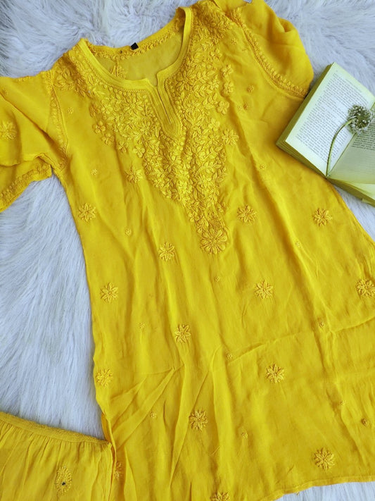 Luxurious turmeric yellow Gharara set by LVW Fashion with intricate Chikankari embroidery, traditional Indian ethnic wear.