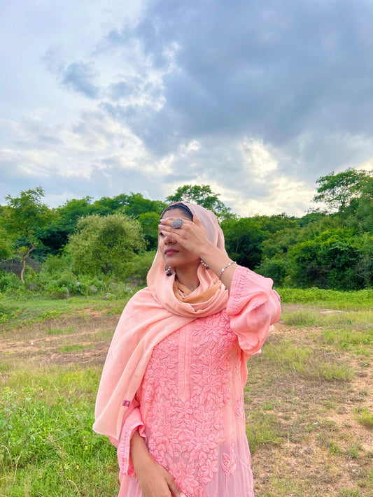 Peach-colored silk long kurta with shining finish, LVW Fashion Luxurious Chikankari, paired with matching pants and dupatta.