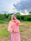 Peach-colored silk long kurta with shining finish and chikankari embroidery, paired with matching pants and dupatta by LVW Fashion.